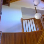 white wall painted by DJJP painting services with exposed wooden beams and wooden stairwell